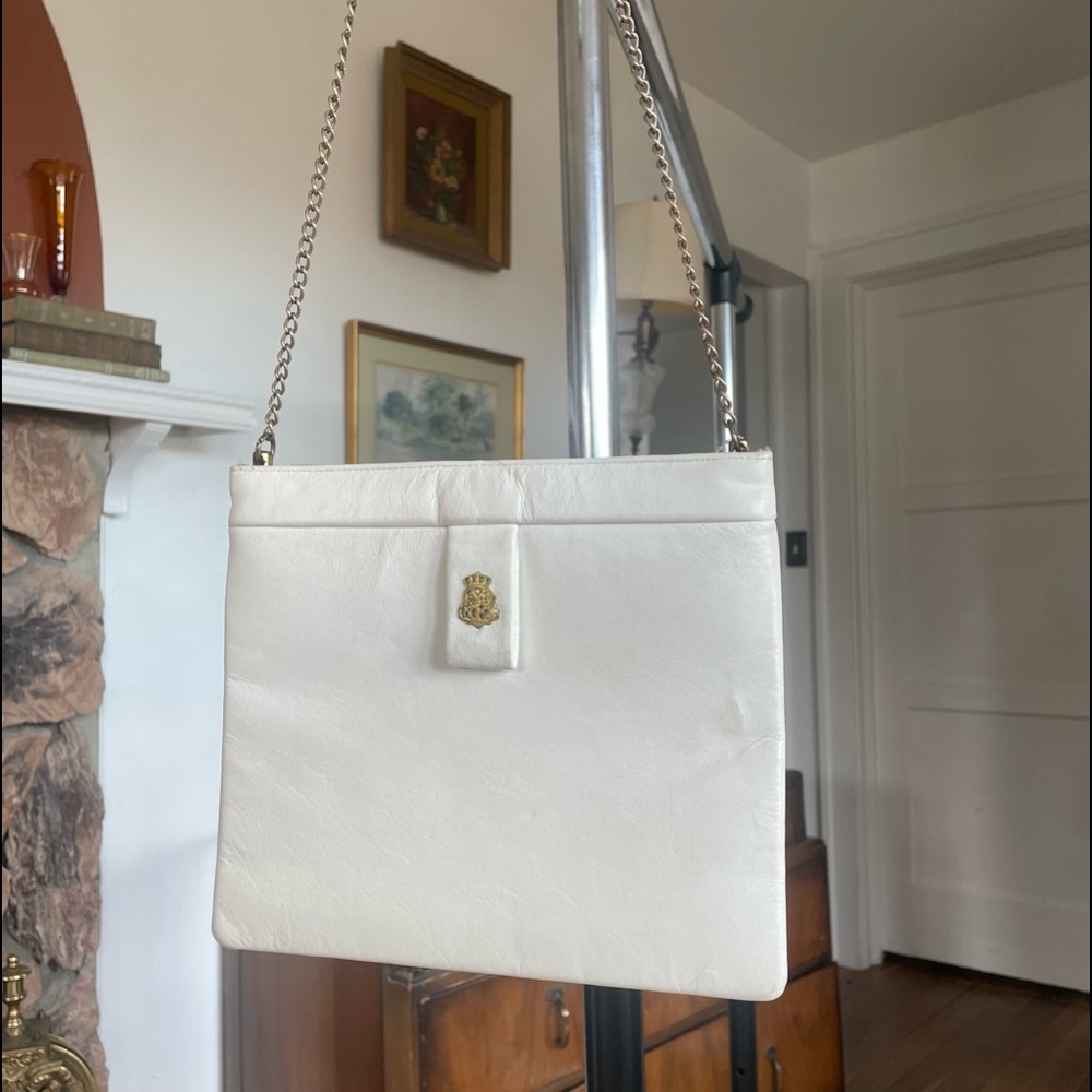 White square purse with built in bar snap closure.